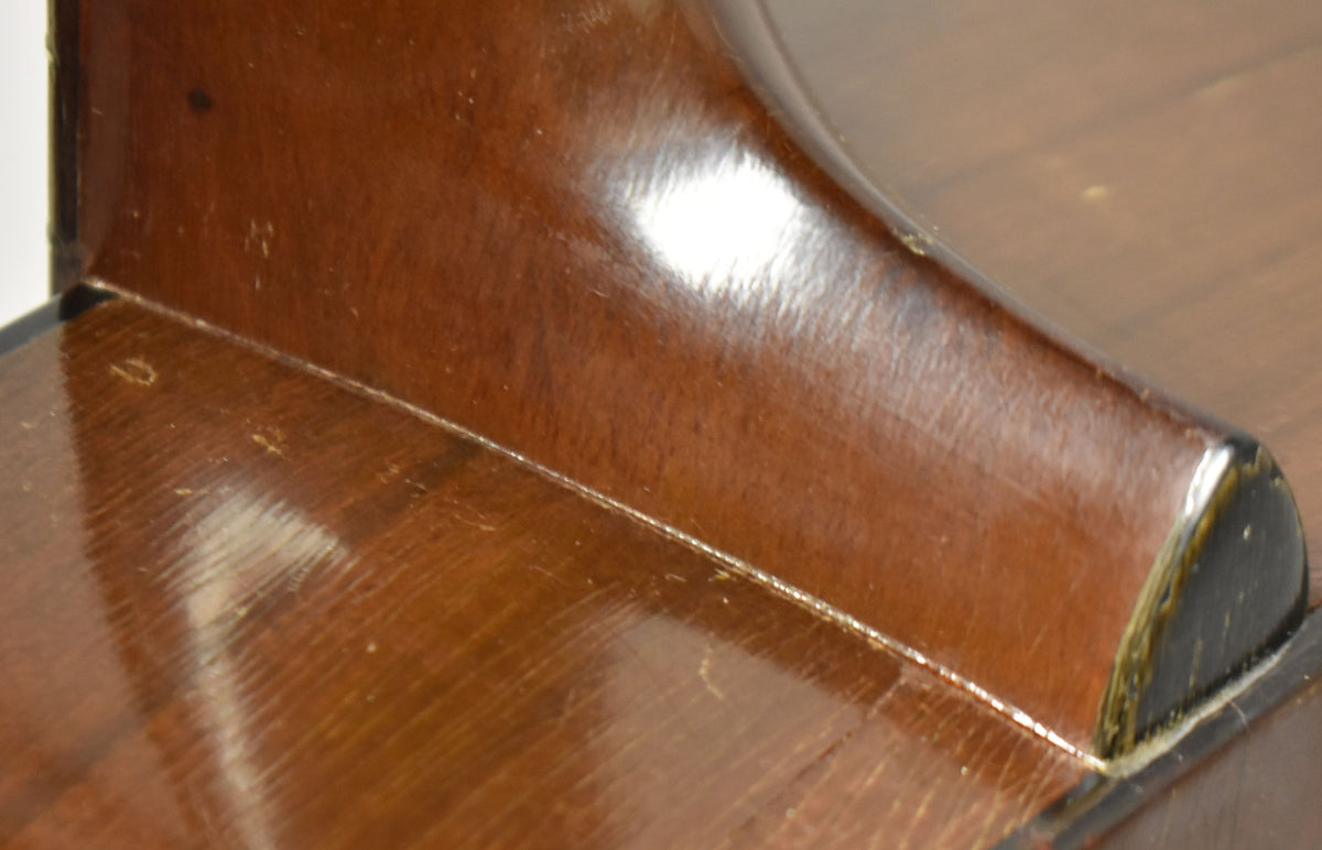 Close-up of the guitar's dark brown neck heel and body joint, showing significant finish wear, scratches, and a chipped binding.