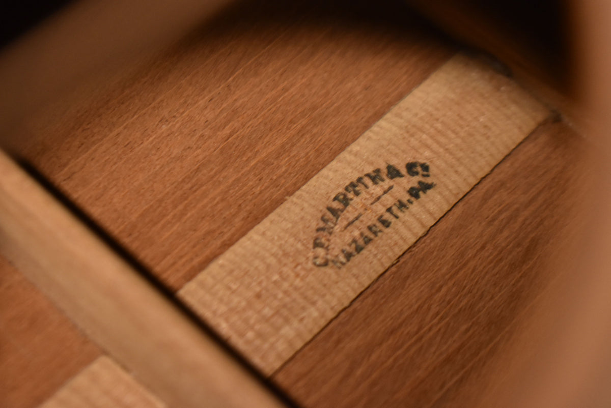Close-up of the guitar's interior, showing the natural wood grain and a light-colored paper label with faded black text.