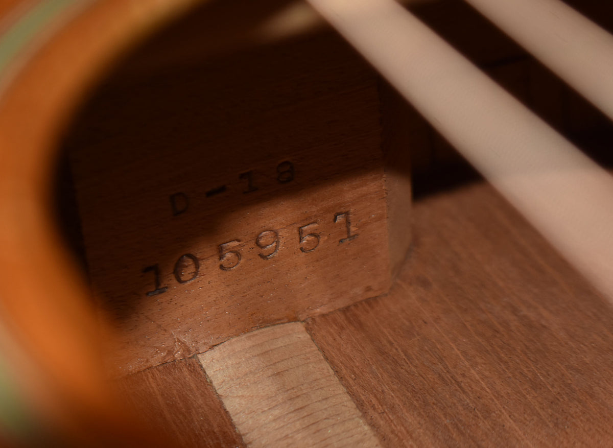 Inside the guitar, the natural wood neck block is stamped with "D-18" and the serial number "105951".