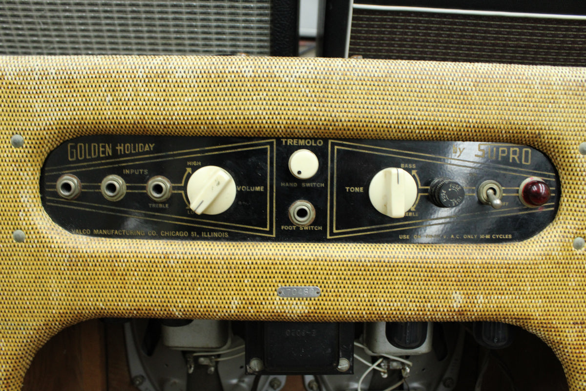 Close-up of a "Golden Holiday by Supro" amp's control panel with inputs, volume, tremolo, tone, and power switch.