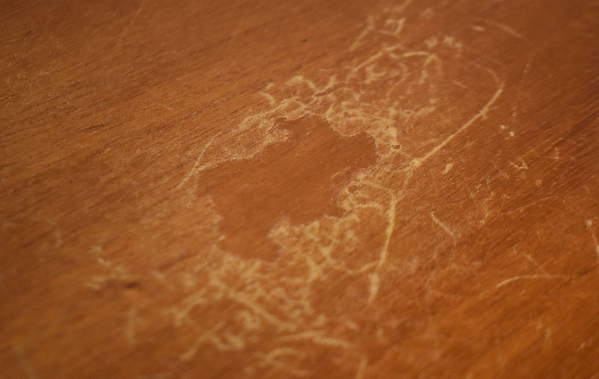 Close-up of the guitar's body, showing extensive finish checking and wear, with lighter wood visible through the dark brown refinish.