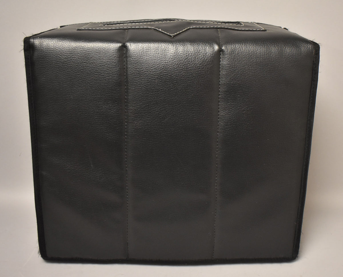 Black padded vinyl cover for the amp, viewed from the front, with white stitching on the top handle and some light scuffs.