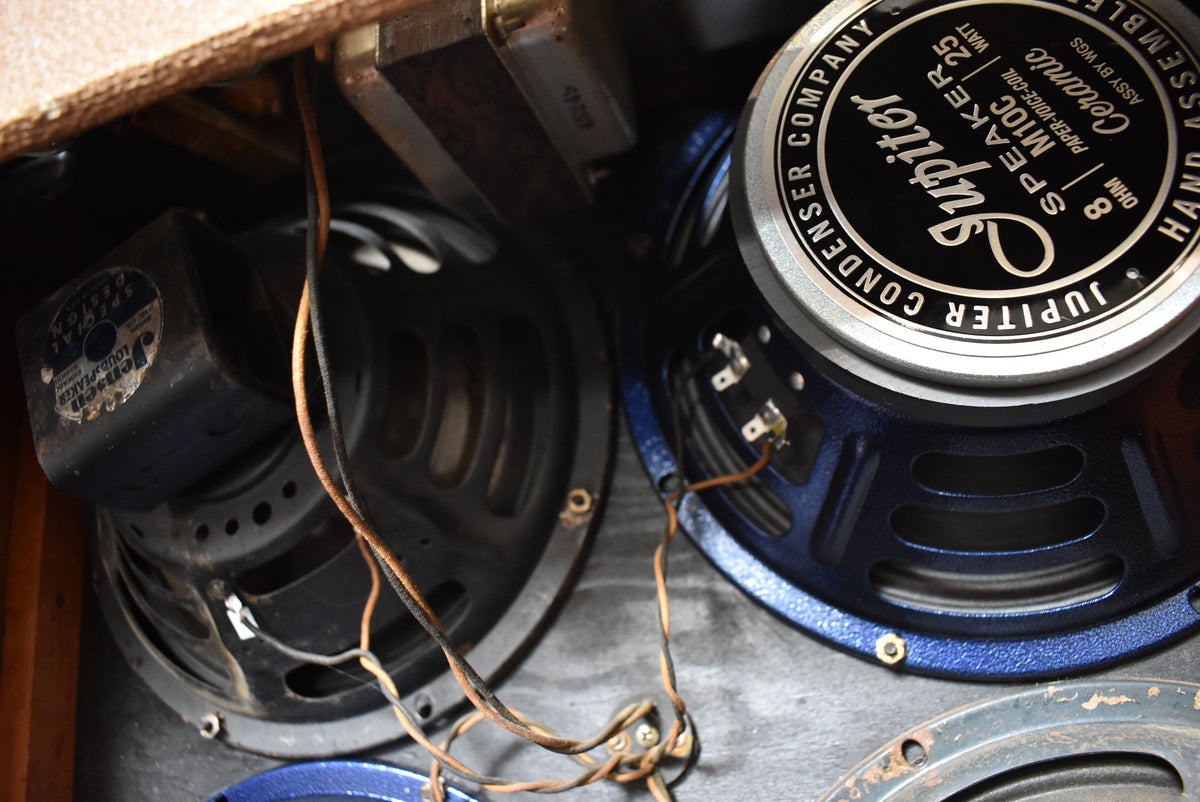 Close-up of three speakers inside an amplifier, one with a "Jupiter Condenser Company" label, and a "Jensen Special Design Loudspeaker" label on another.