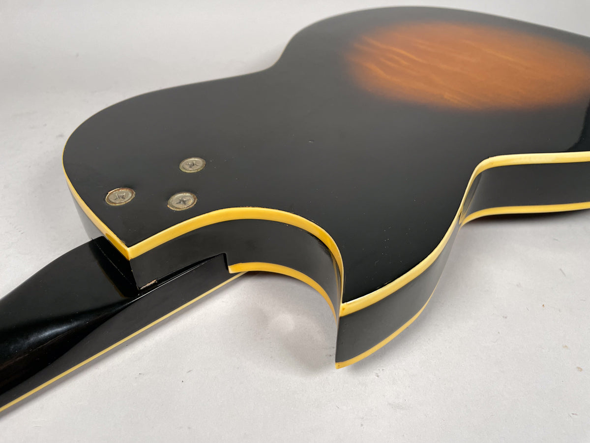 The back of a sunburst guitar body with a black neck, showing the neck joint and three screws.