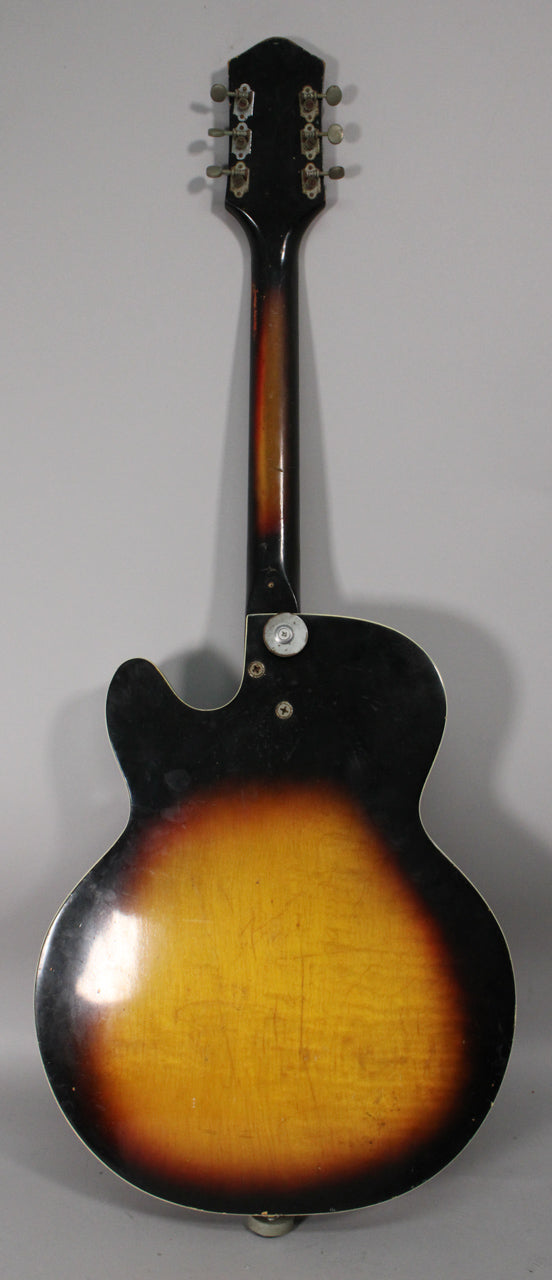 The guitar's back, headstock, and neck are visible, showing a sunburst finish with heavy wear and six chrome tuners.