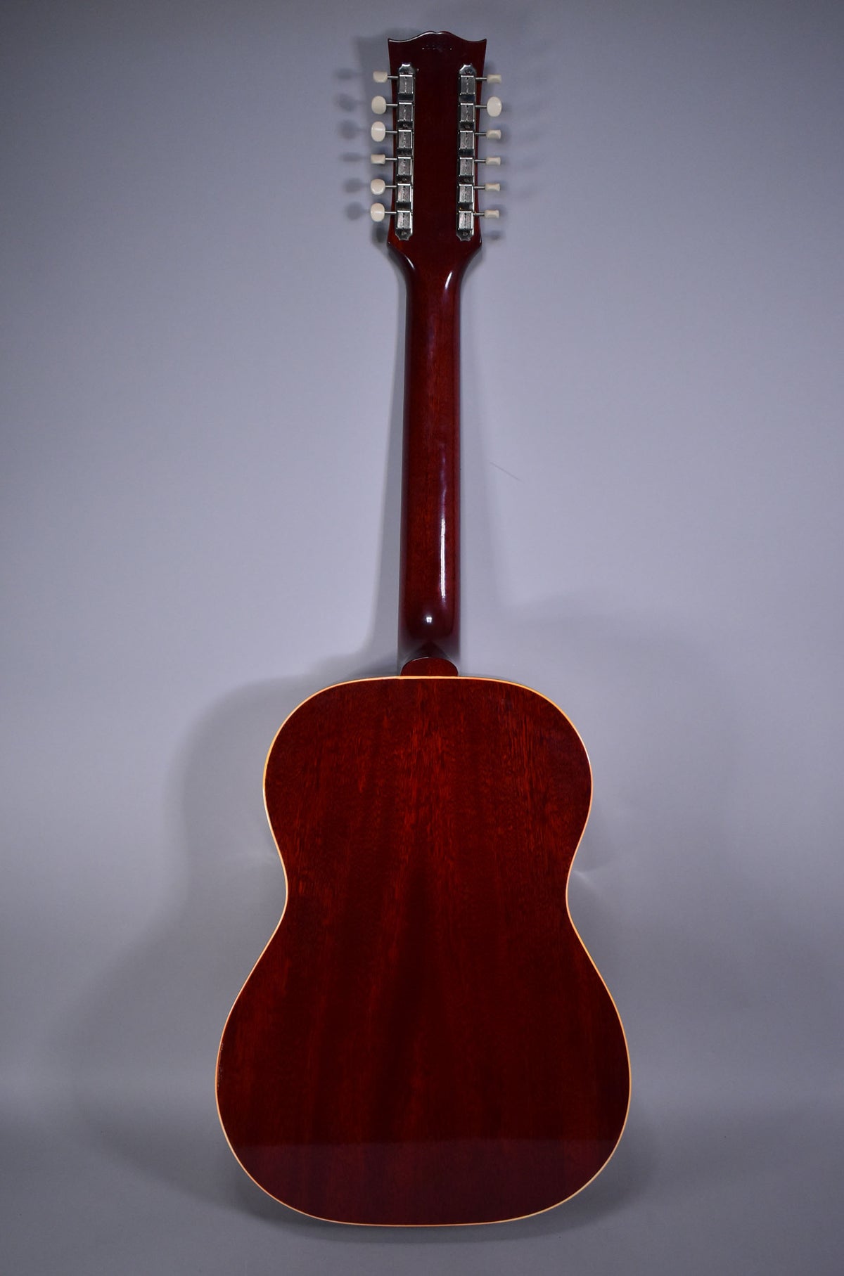 Full rear view of a dark cherry sunburst 12-string acoustic guitar with a glossy finish, showing the headstock, neck, and body.
