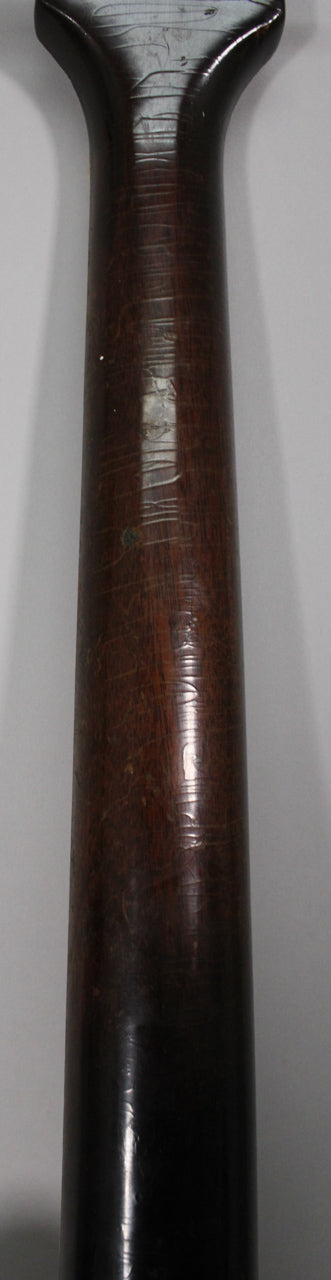 The dark brown neck and heel of the guitar show extensive finish checking, wear, and some lighter spots where the finish has chipped away.