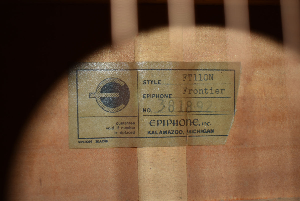 Close-up of the guitar's interior label, showing "FT110N Frontier" and "Kalamazoo, Michigan" on aged, slightly creased paper.