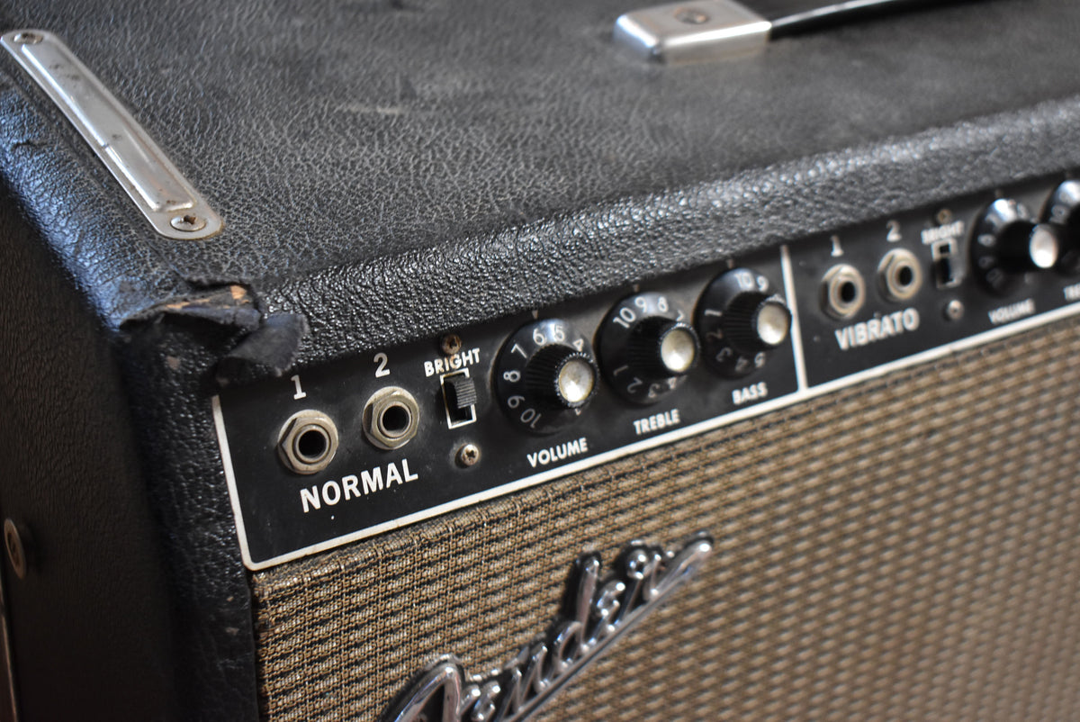 Close-up of the black tolex amp's control panel, showing wear on the top left corner, with "Normal" and "Vibrato" channels.