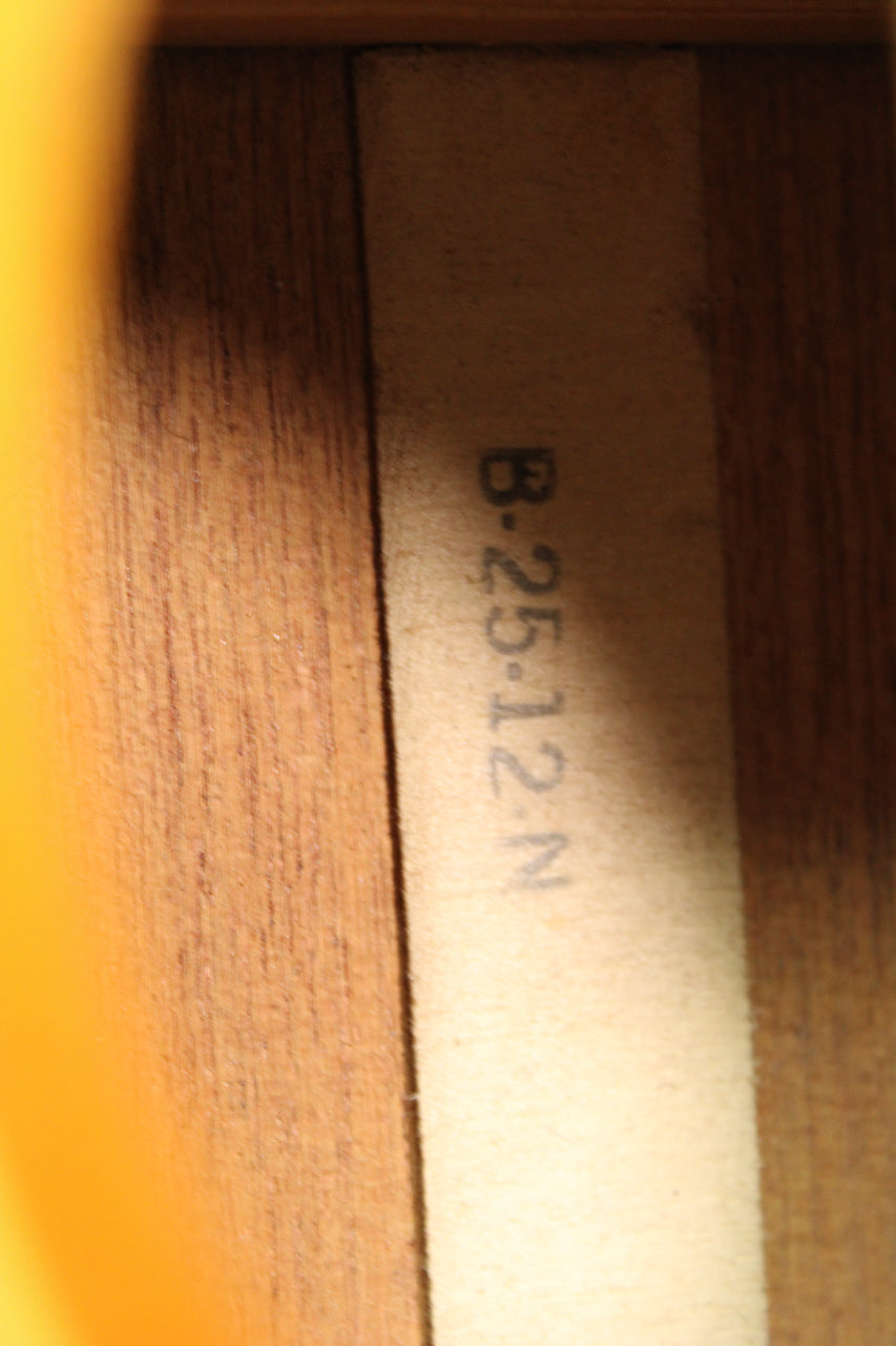 A close-up of the guitar's interior, showing a light-colored label with "B-25-12-N" printed vertically in dark gray.