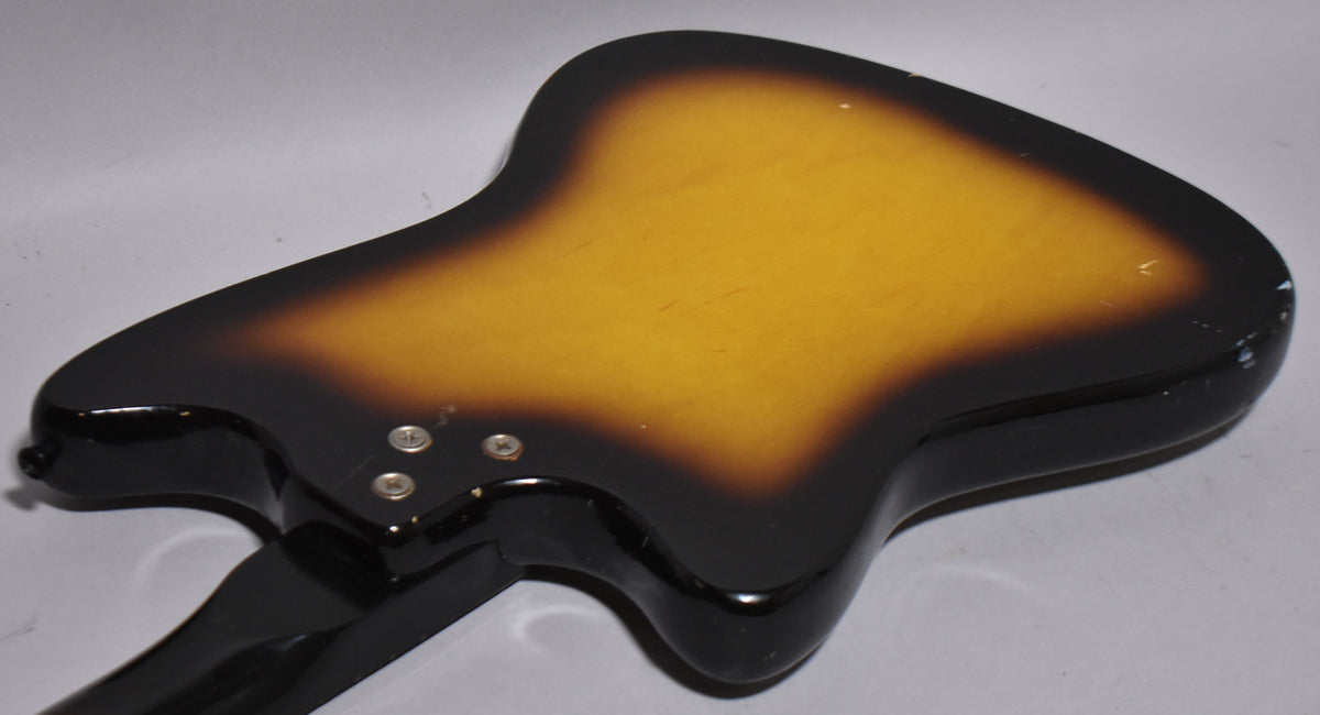The back of a sunburst guitar body, showing the neck joint and strap button, with visible wear and finish checking.