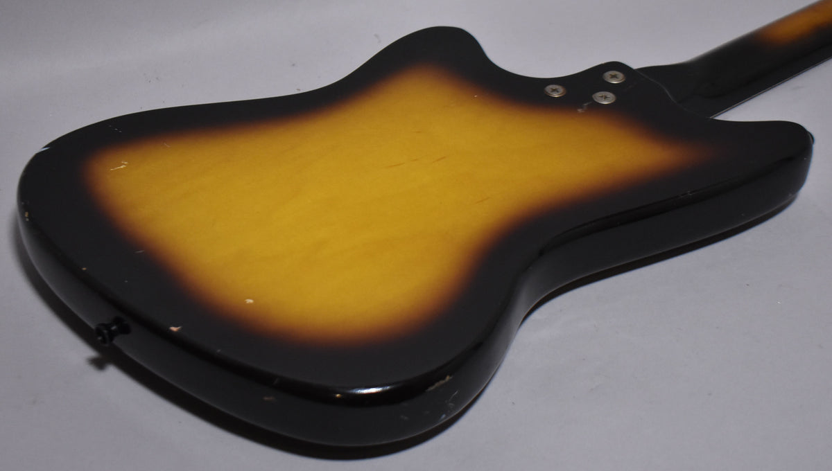 The guitar's back shows a sunburst finish with a black edge, yellow center, and visible wear, nicks, and checking.