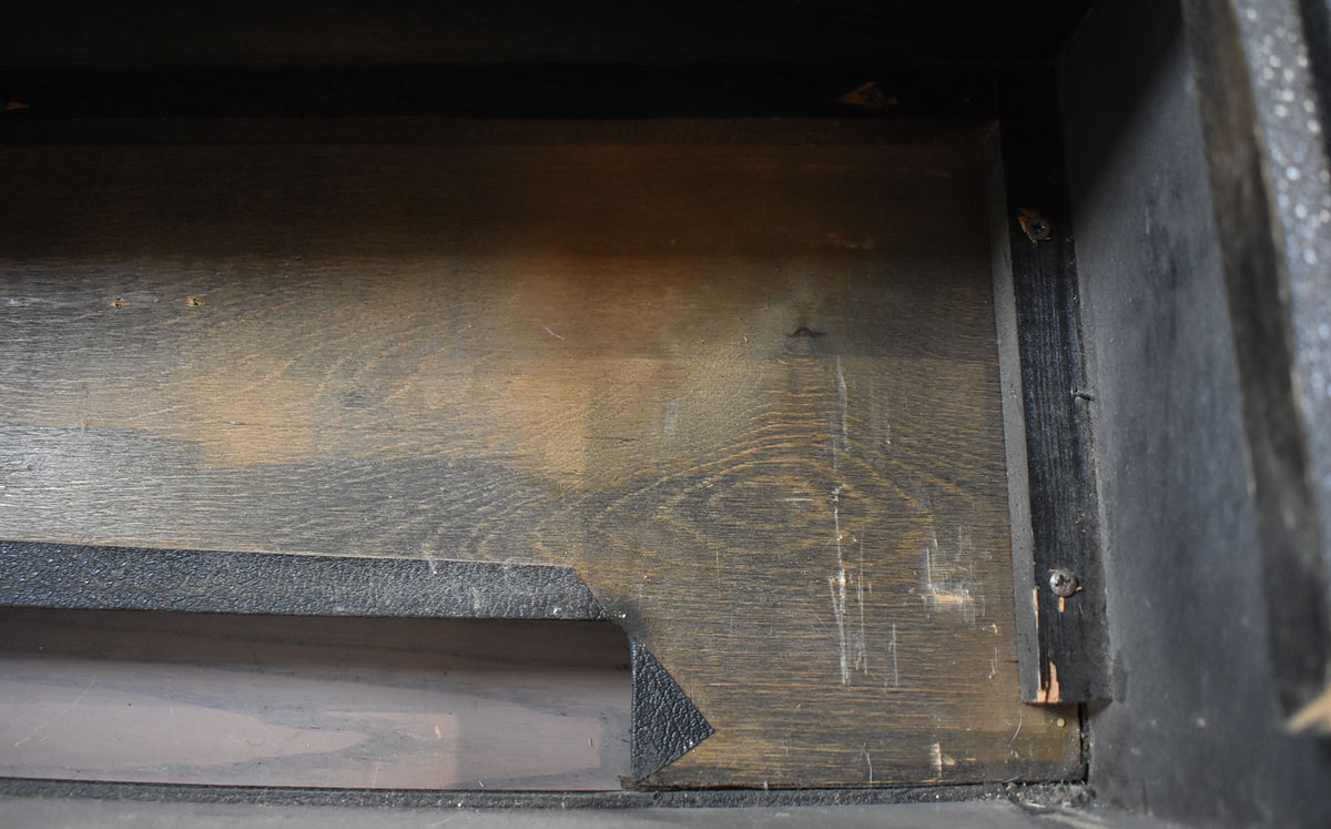 Top-down view of the amp's dark wood interior, showing a cut-out section and visible scratches on the wood grain.