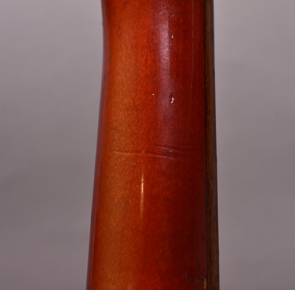 Close-up of the Fireglo neck, showing finish wear, a few small dings, and some horizontal checking lines.