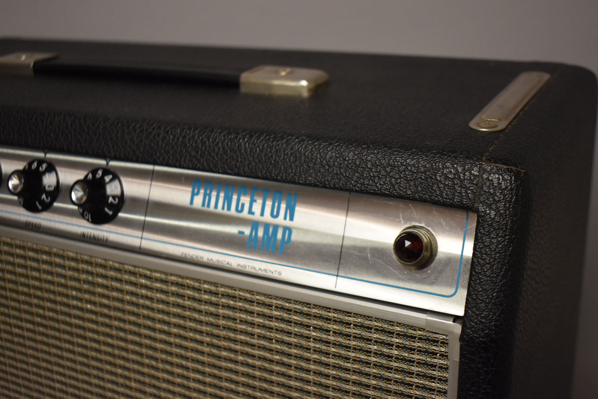 Close-up of the amp's top right, showing the black textured tolex, silver control panel with two black knobs, and a red pilot light.