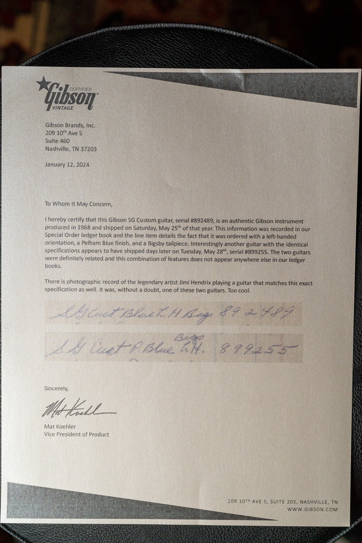 A close-up of a Gibson letter of authenticity, detailing the guitar's Pelham Blue finish, left-handed orientation, and Bigsby tailpiece.