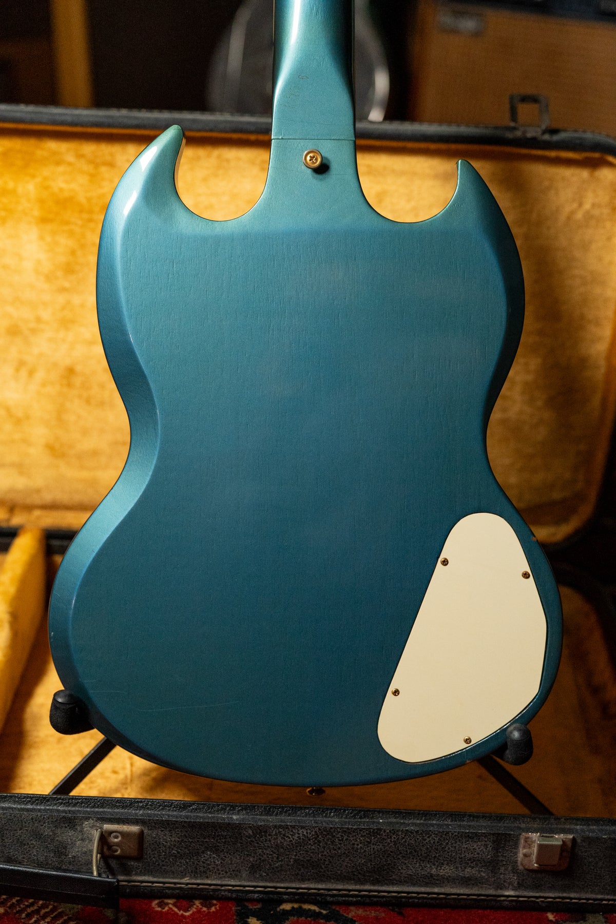 The back of a Pelham Blue SG Custom, showing a matte finish, light wear, and a cream-colored control cavity cover.