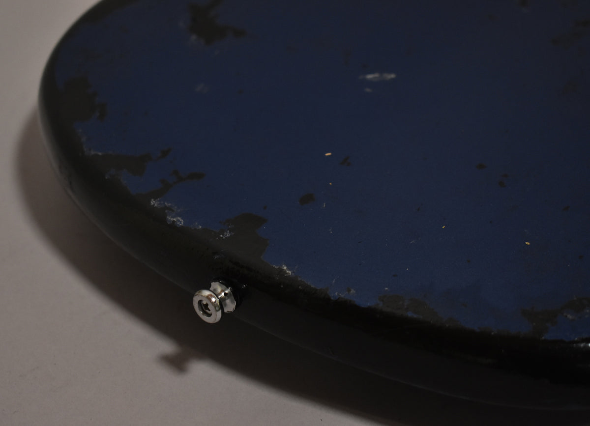 Close-up of the bass's lower bout, showing the metallic blue finish with significant chipping and a chrome strap button.