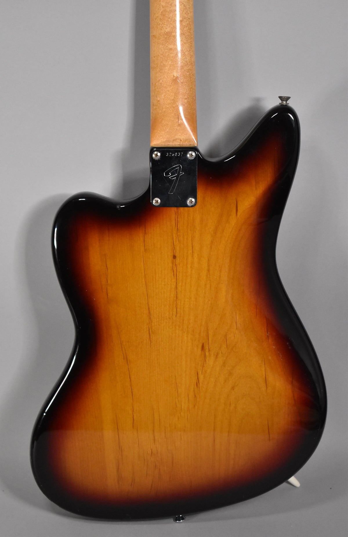 Rear view of a 3-Tone Sunburst guitar body, showing the neck joint, neck plate with serial number, and a strap button.
