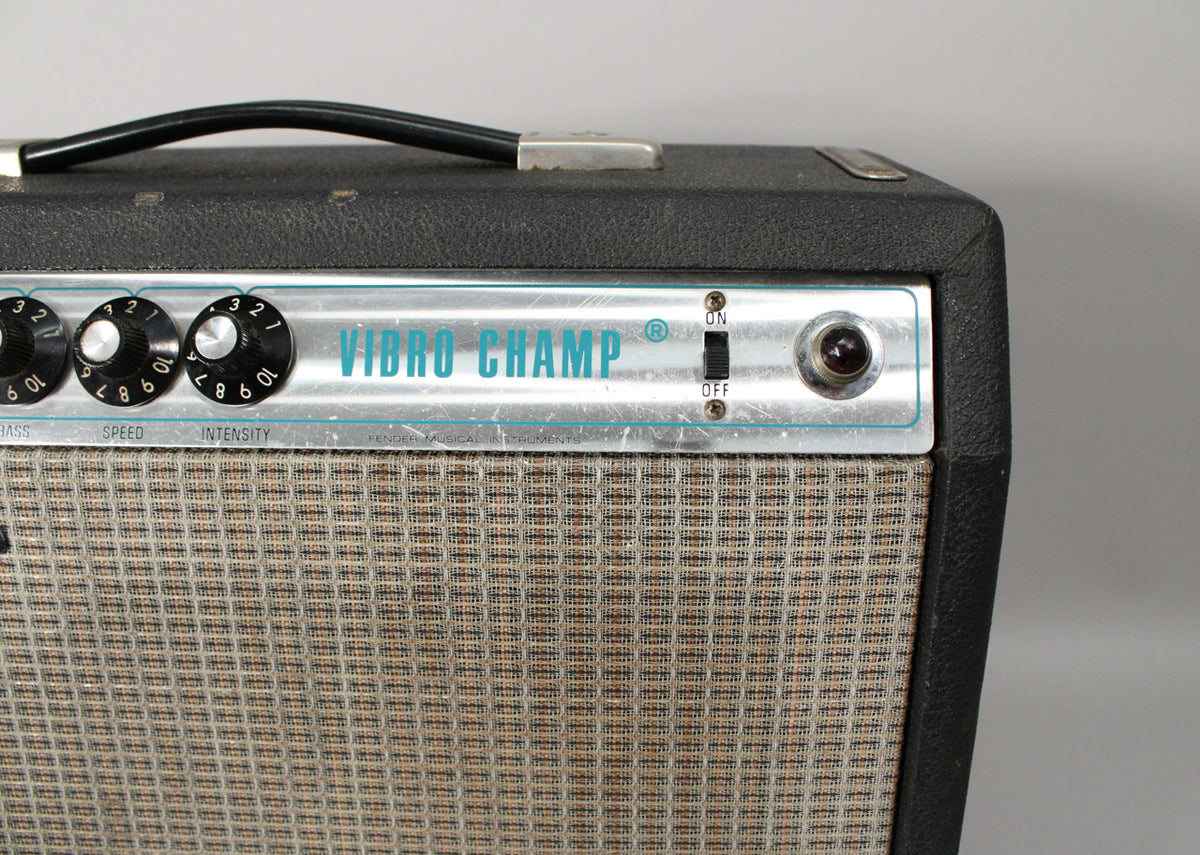 The top right of the black amp shows a silver control panel with three black knobs, an on/off switch, and a red pilot light.