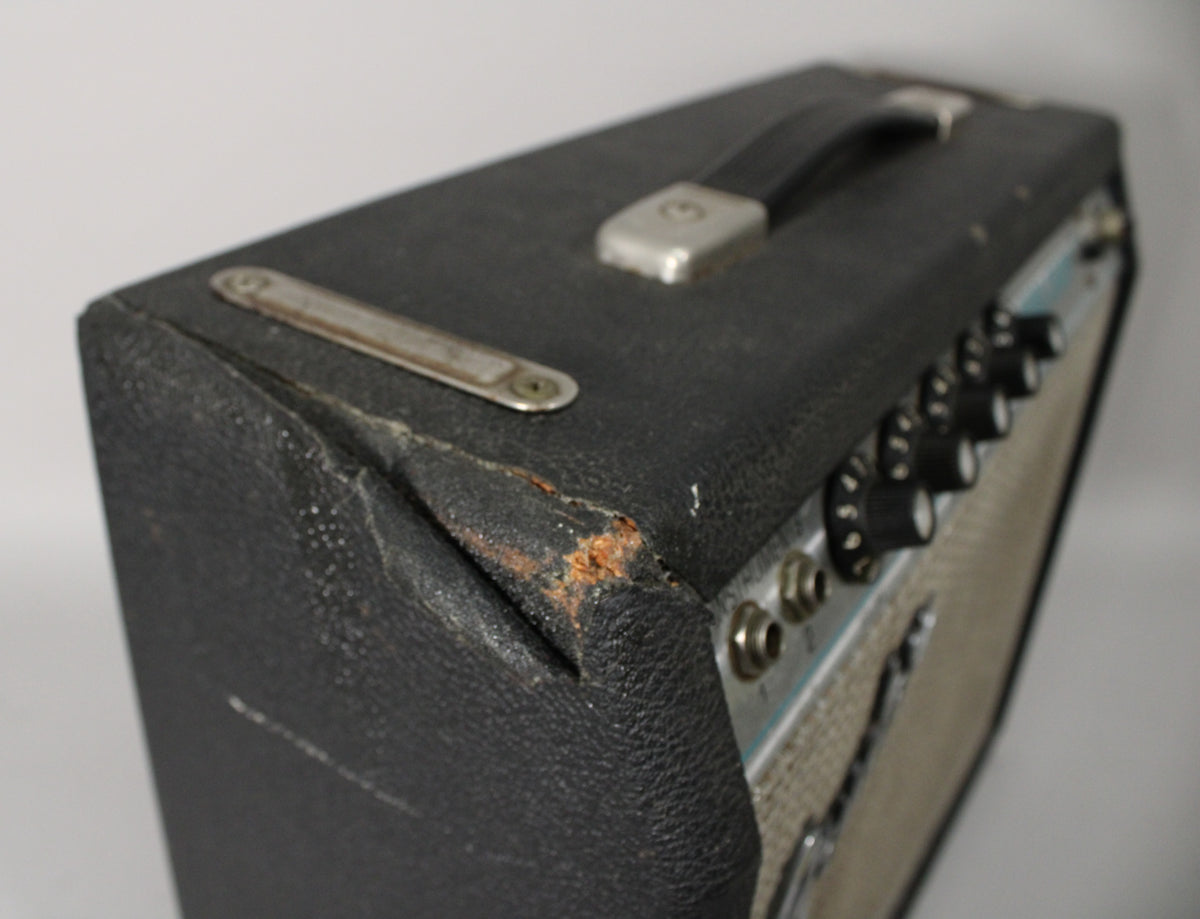 Close-up of the amp's top and right side, showing worn black tolex, a chrome handle, and six black control knobs on the silverface panel.