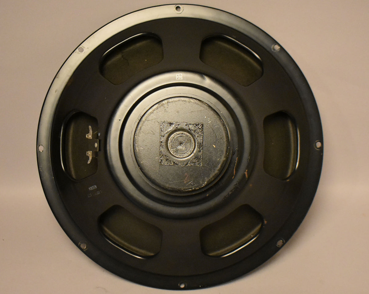 Rear view of a round, black speaker with a metal center, two terminals, and "423304" printed on the frame.