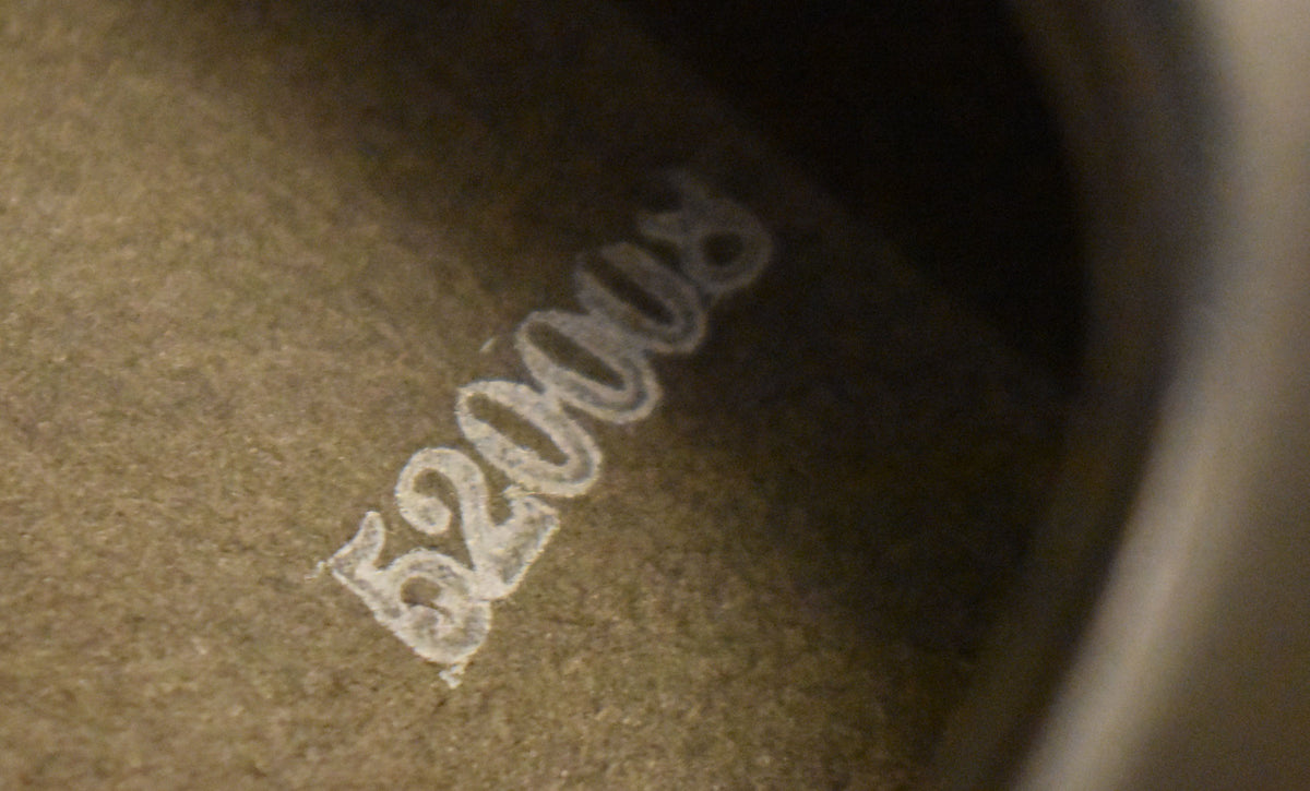 Close-up of the speaker cone's textured, dark brown surface with faded white numbers "62008" stamped diagonally.