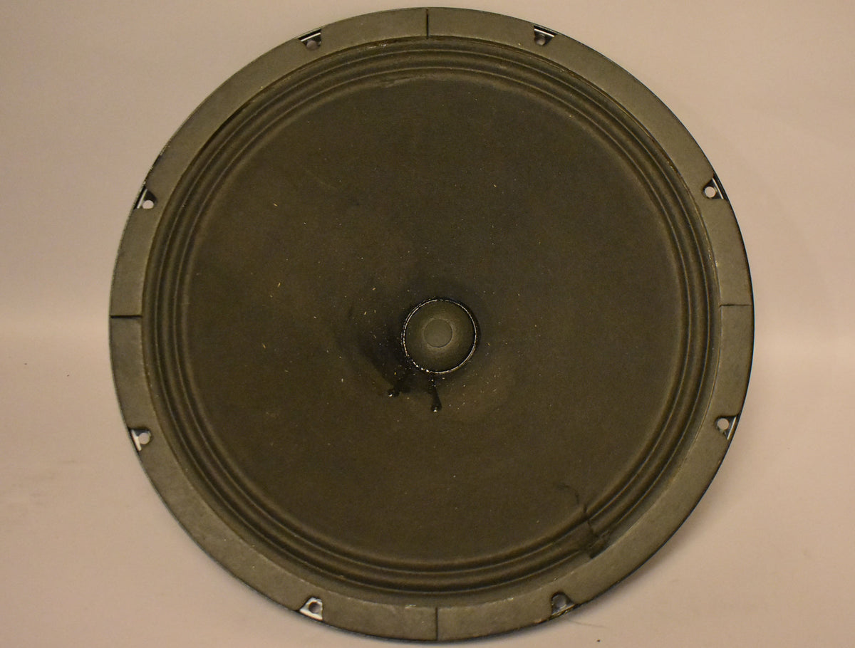 Front view of a dark grey speaker with a slightly faded cone, showing 10 mounting holes around the rim.