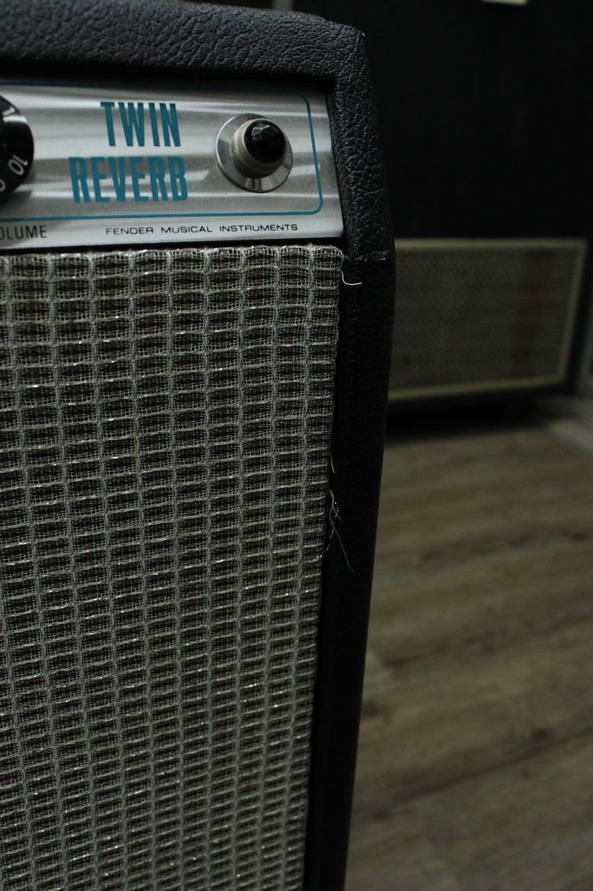 Close-up of the amp's upper right, showing the silver control panel, a black knob, a black input jack, and the silver grille cloth.