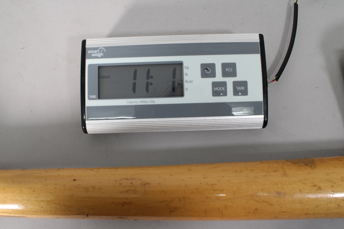 The bass neck, with a worn, ambered finish, rests below a digital scale displaying "11.1".