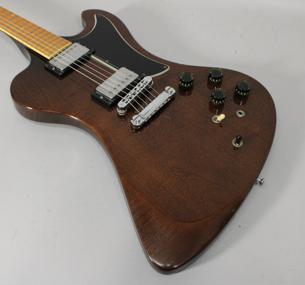 Dark walnut guitar body with a black pickguard, two humbuckers, four black knobs, and a cream toggle switch.
