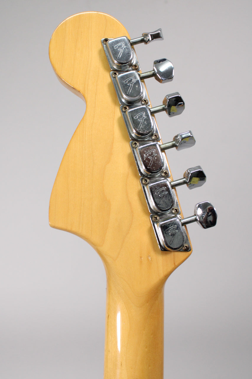 Rear view of the maple headstock and neck, showing six chrome tuners with some pitting and light wear on the finish.