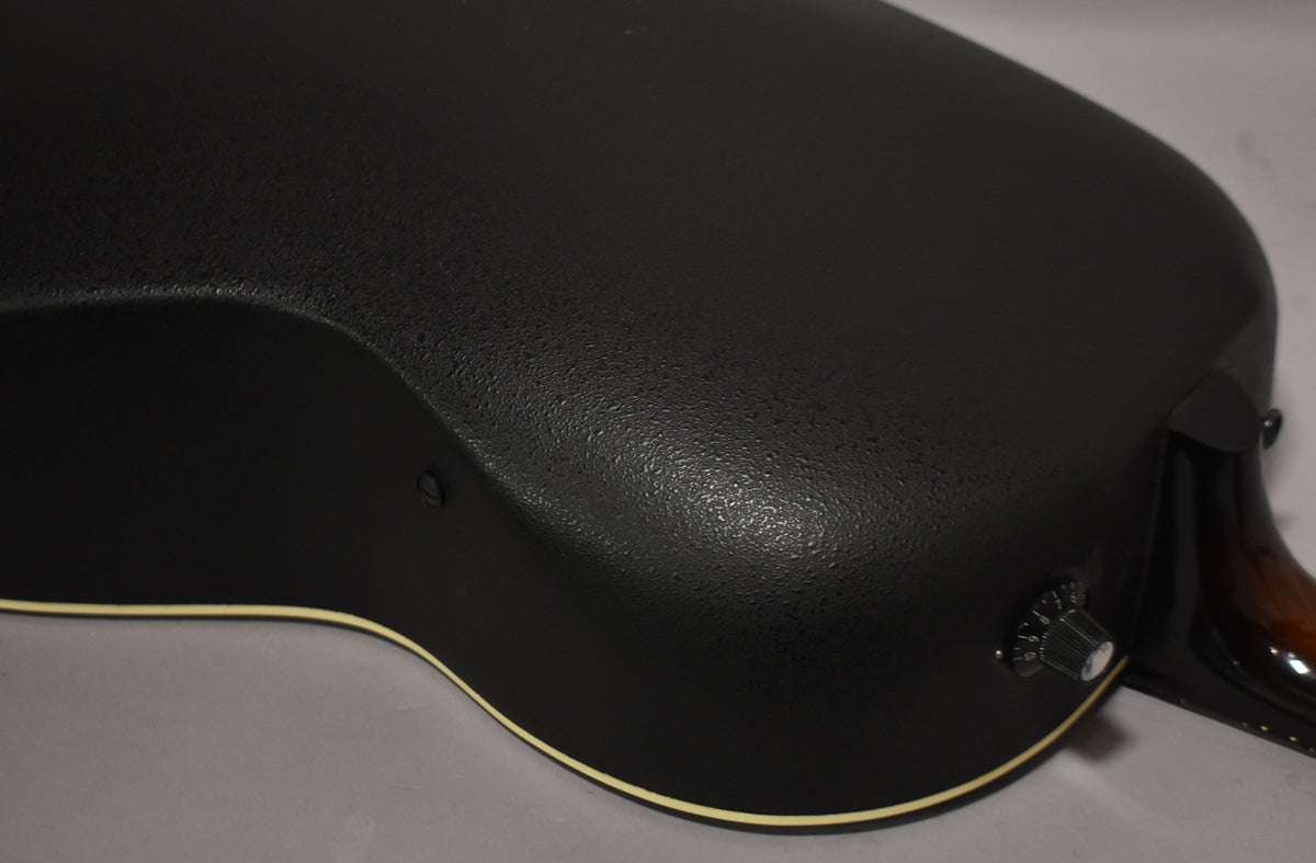 Close-up of the guitar's textured black Lyrachord bowl back, showing a single control knob and the neck heel.