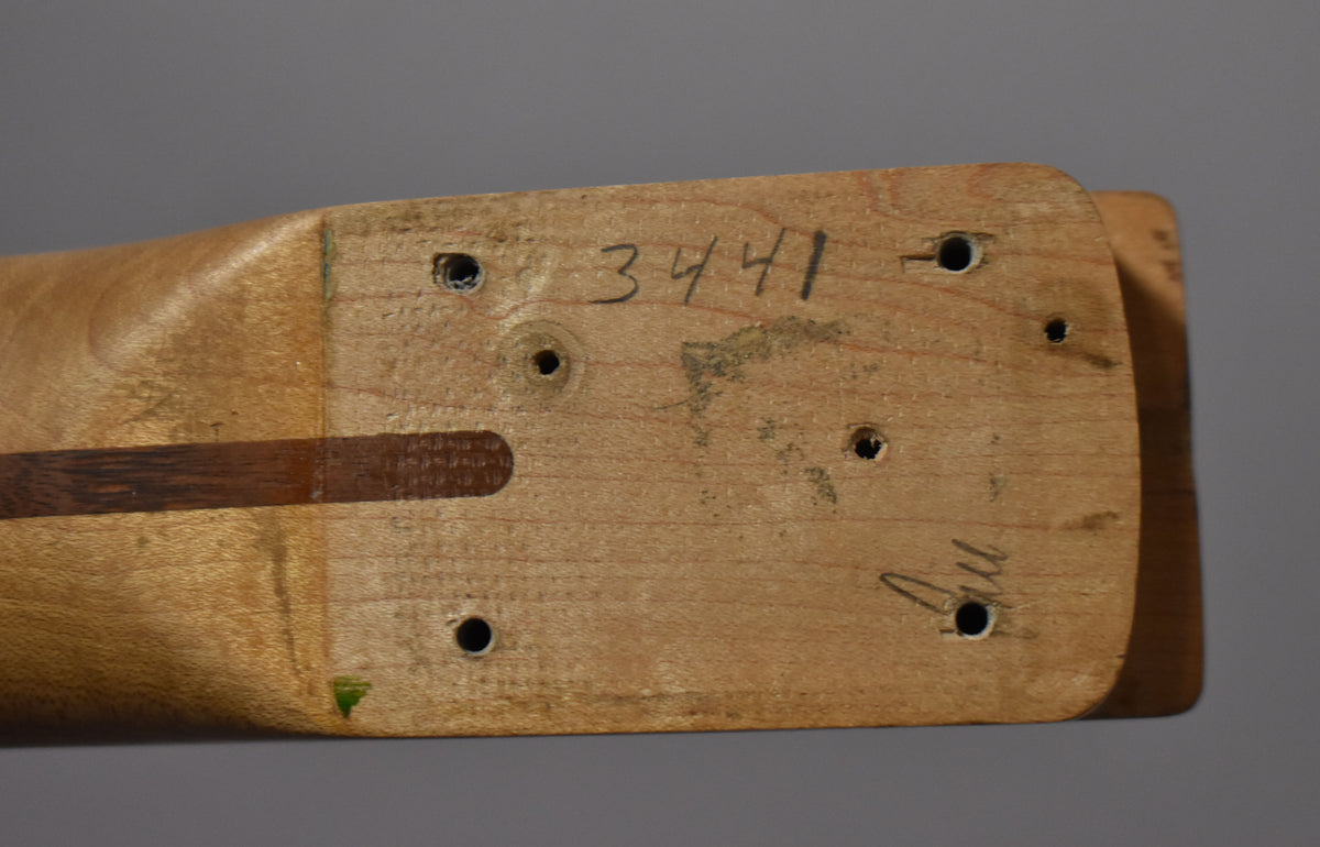 The maple neck heel, viewed from above, shows six screw holes, a dark wood skunk stripe, and handwritten numbers "3441" and "Au".