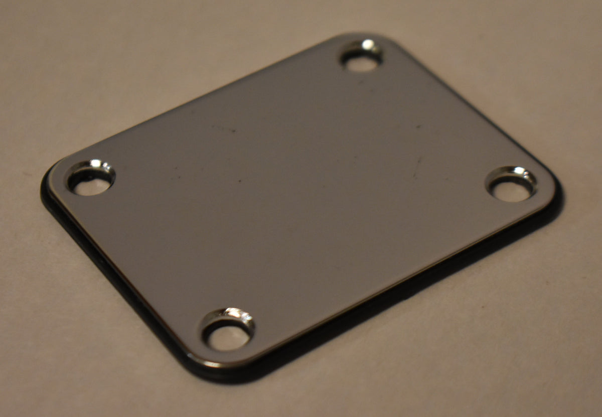 A rectangular chrome neck plate with four screw holes, viewed from a slight angle, showing the black gasket underneath.