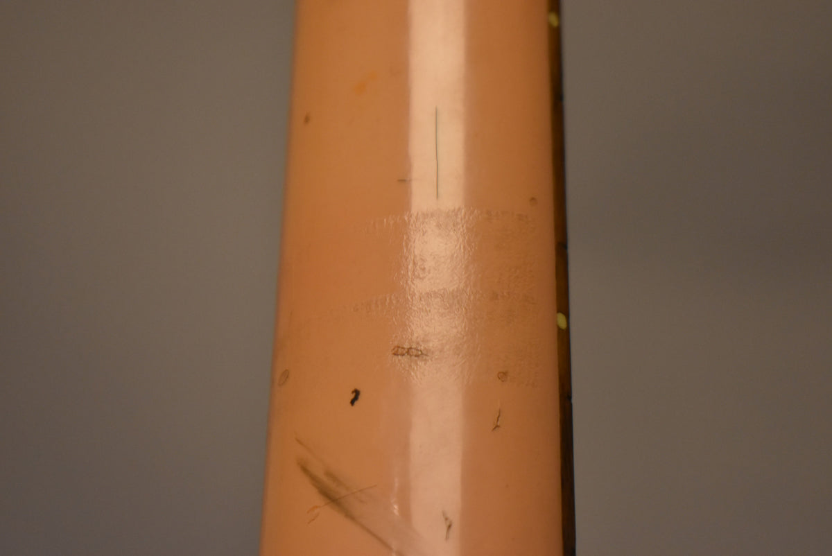 Close-up of the faded pink guitar neck, showing heavy wear, scratches, and finish checking on the back.