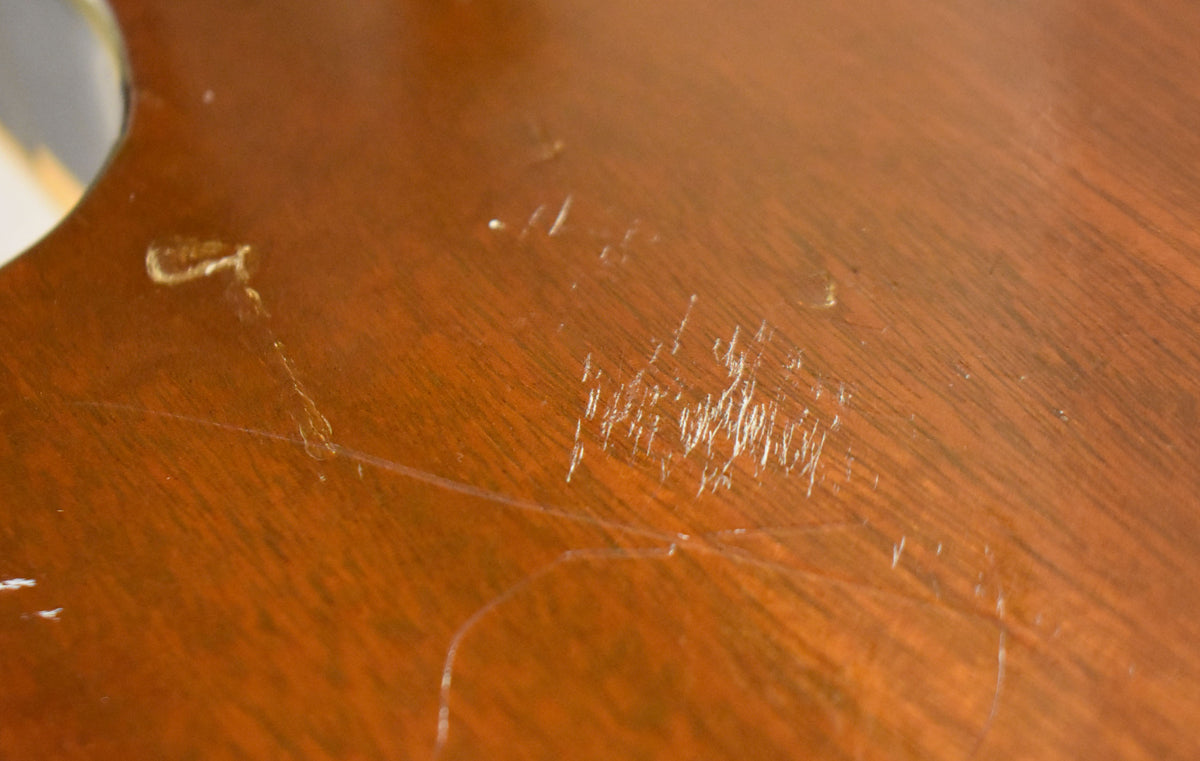 Close-up of the guitar's tobacco burst body, showing numerous light scratches and scuffs on the glossy finish, concentrated in the center.