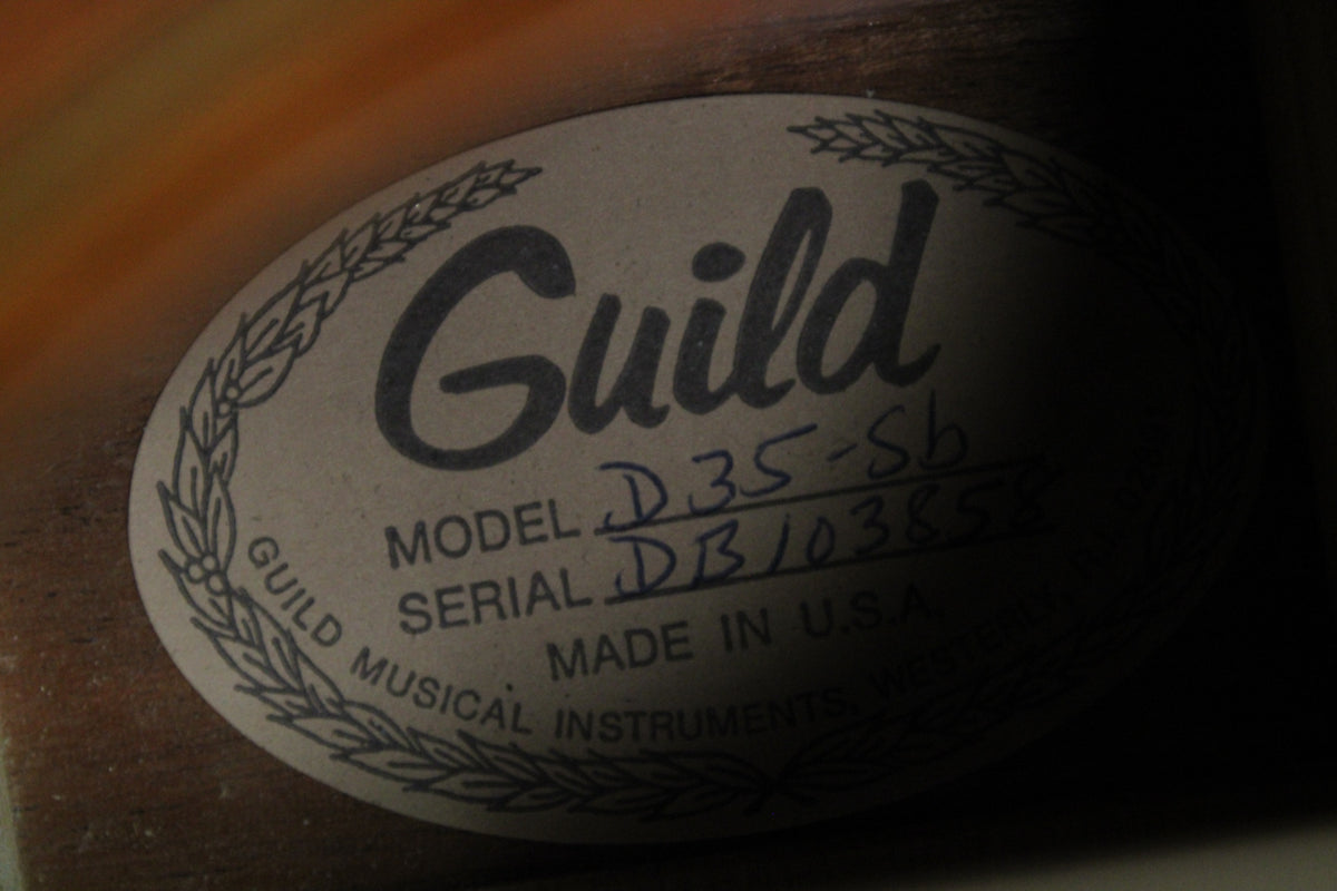Close-up of the guitar's interior label, showing "Guild" in script, "MODEL D35-SB", and "SERIAL DB103858" handwritten.