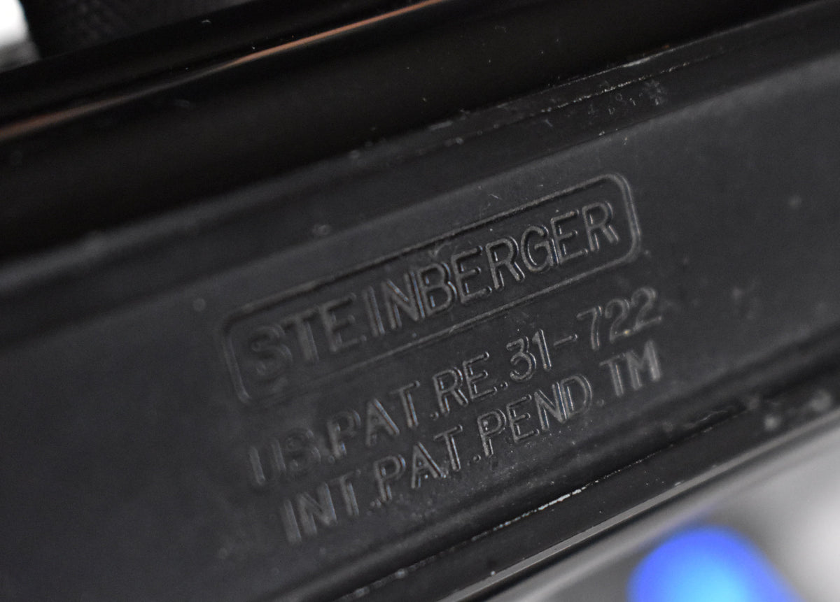 Close-up of the black matte bass body, showing embossed text and light wear along the top edge.