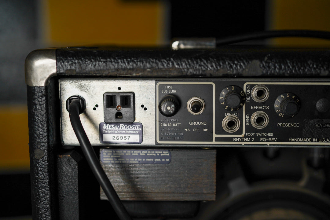 Close-up of the amp's black rear panel, showing the power input, fuse, ground switch, effects loop, and presence knob, with some wear.