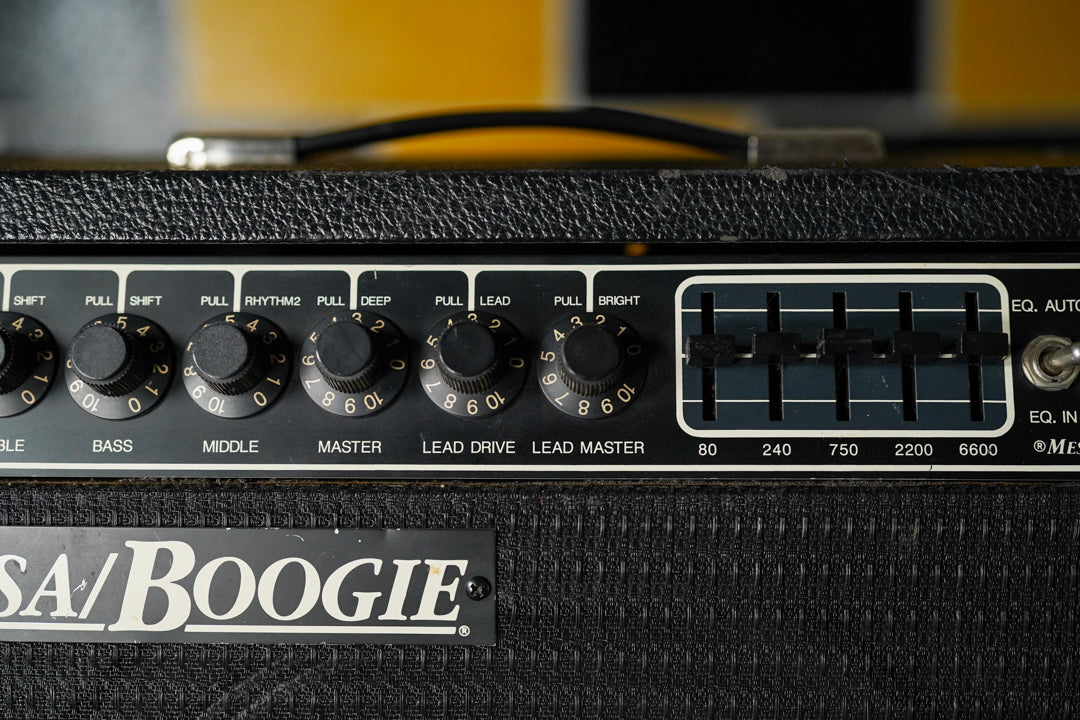 Close-up of the black textured control panel, showing nine black numbered knobs and a five-band graphic EQ with black sliders.