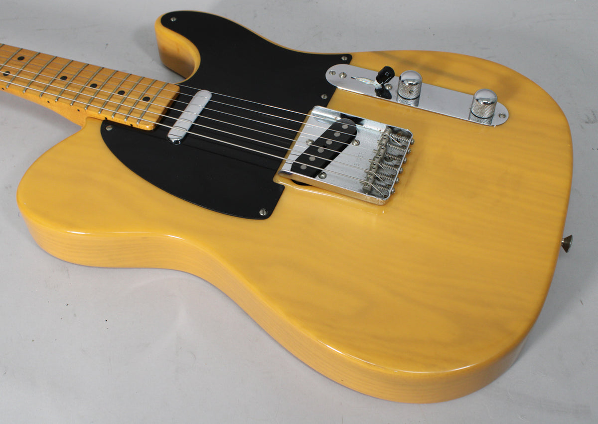 Butterscotch blonde Telecaster body, angled from the neck, showing a black pickguard, chrome bridge, and control plate.