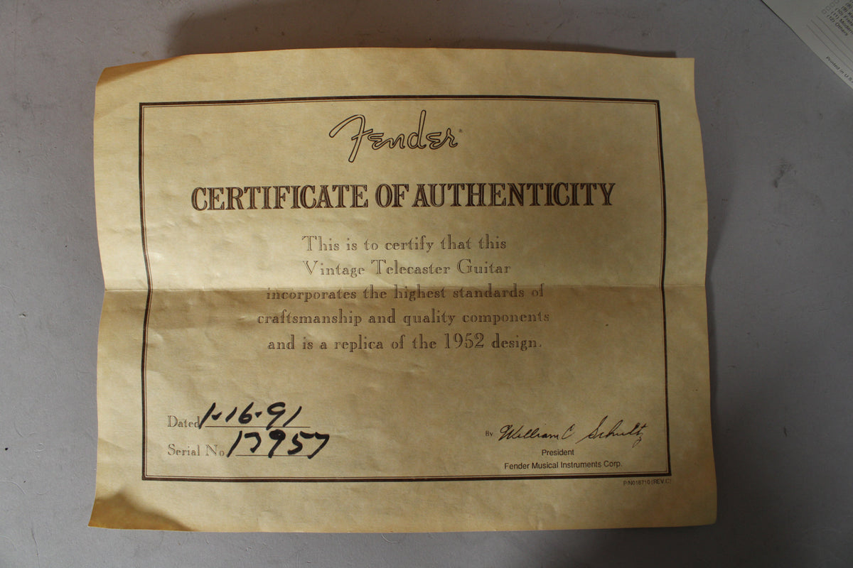 A full view of the folded, aged tan certificate of authenticity, dated 1-16-91 with serial number 17957.
