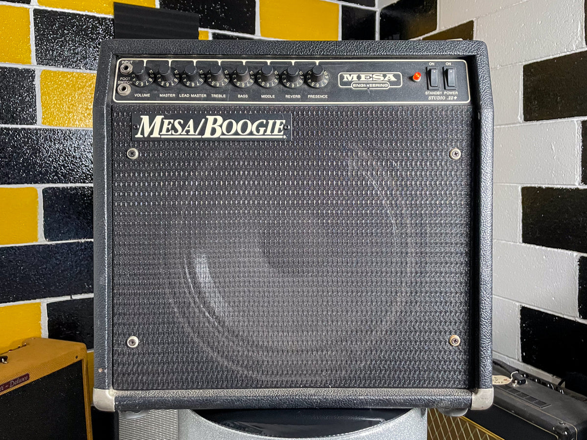 Front view of a black textured combo amp with a dark gray grille, 8 black knobs, and two power switches.
