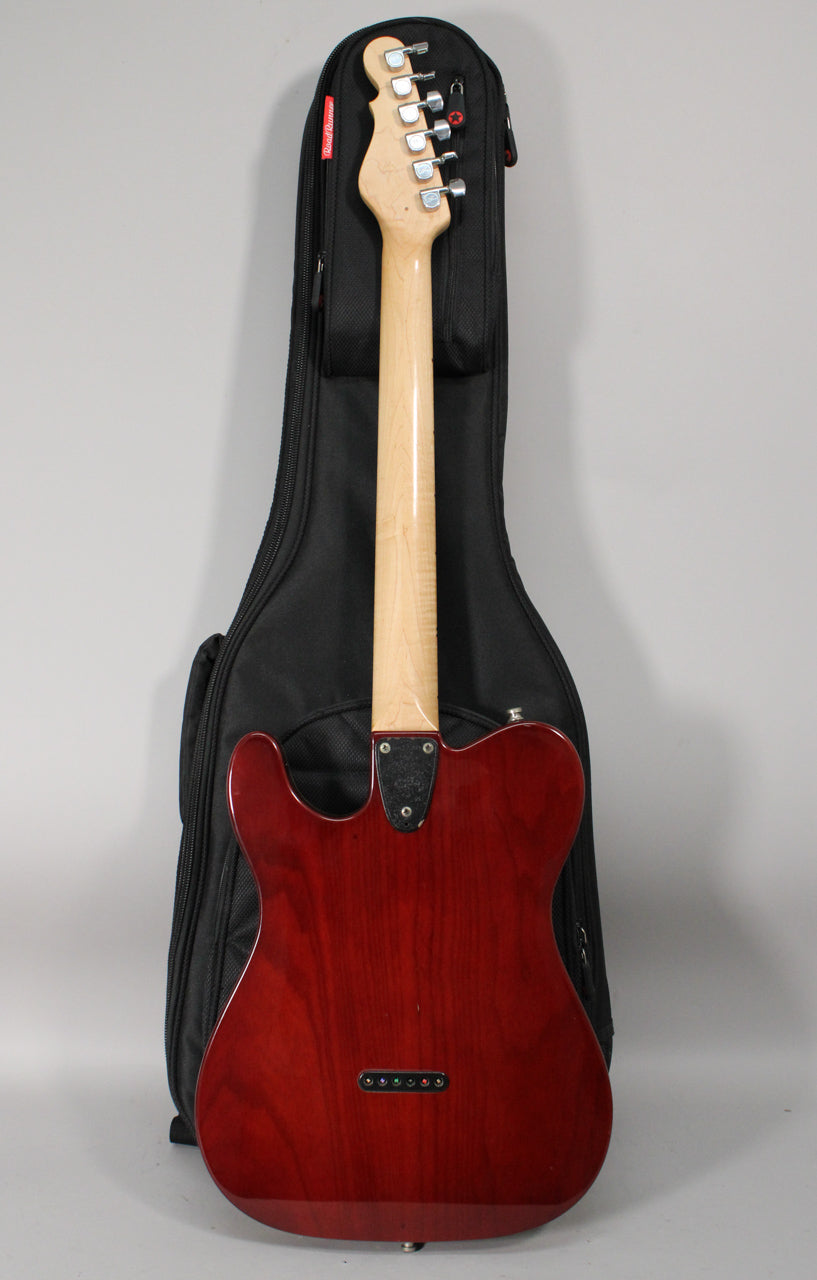 The guitar's back is visible, showing a dark red sunburst finish, a light maple neck, and six string ferrules.