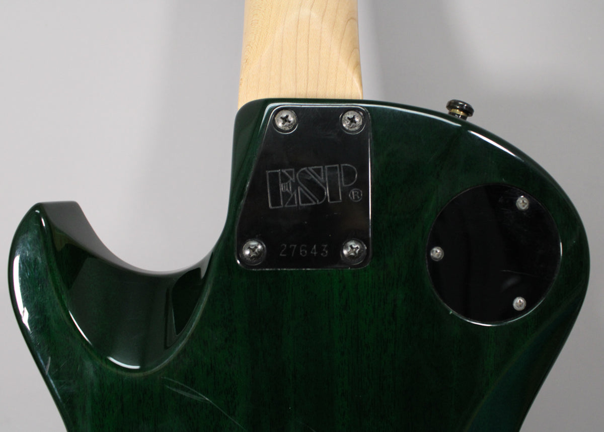 Rear view of the guitar's upper body, showing the dark green translucent finish, neck plate, and control cavity cover.