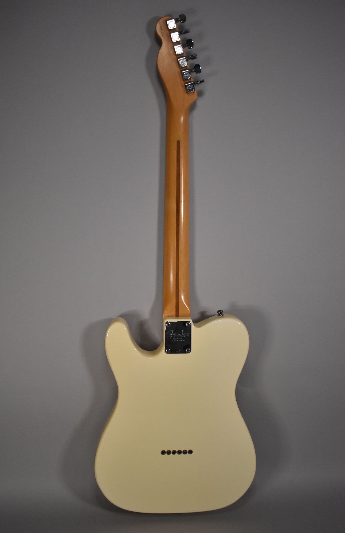 Full rear view of an Olympic White Telecaster, showing the maple neck, chrome tuners, and six string-through-body ferrules.