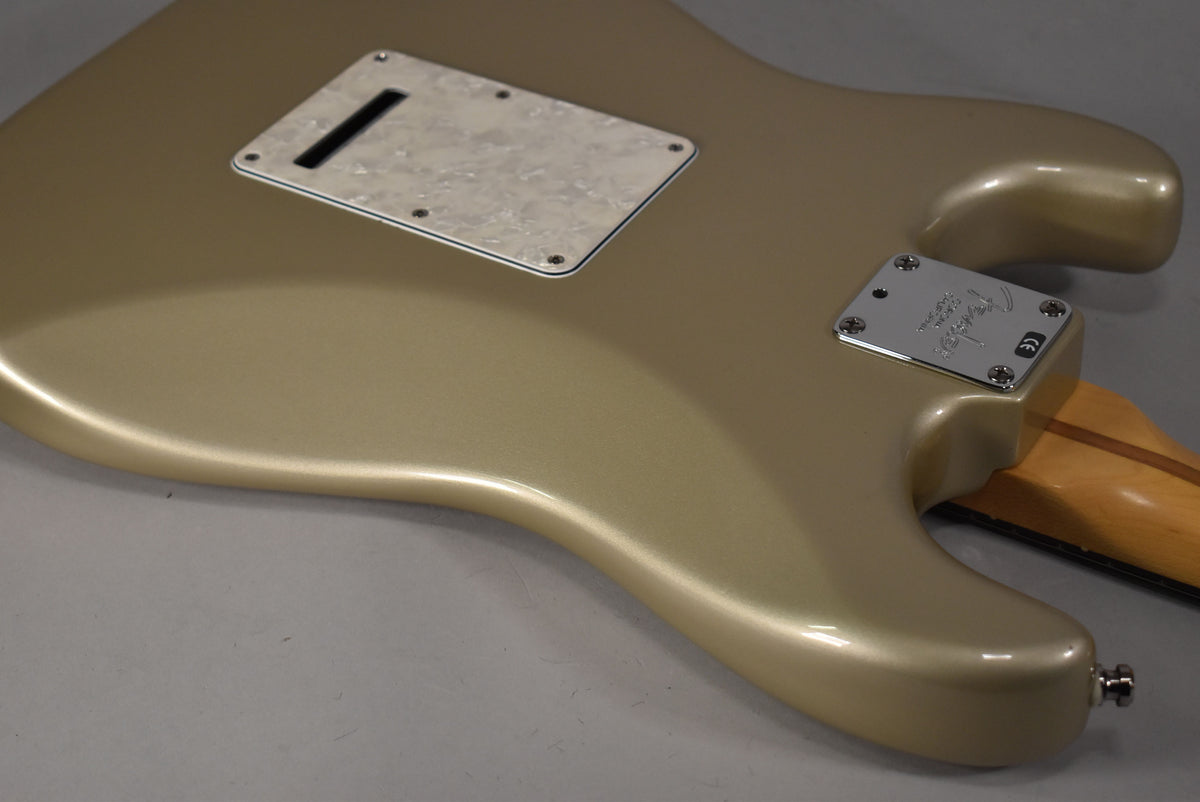 Back of a Shoreline Gold Stratocaster body, showing the tremolo cover, neck plate with Fender logo, and part of the maple neck.