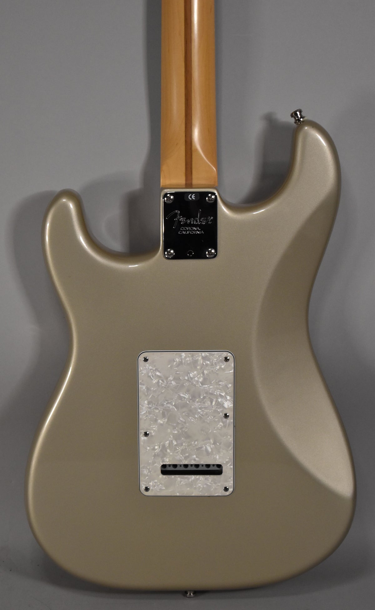 Back of a Shoreline Gold Stratocaster with a maple neck, chrome neck plate, and a pearloid tremolo cover.