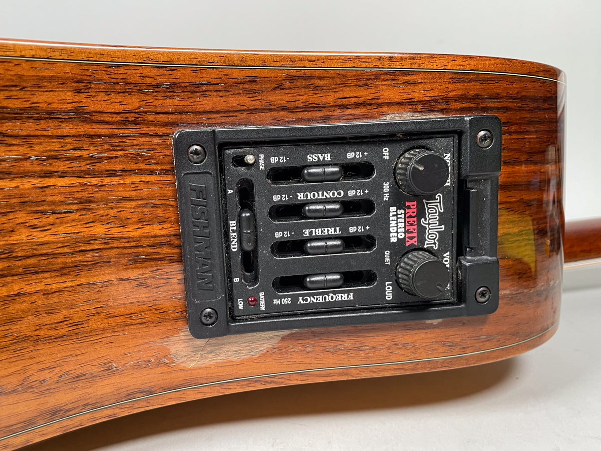 Close-up of the guitar's side, showing the black Fishman Prefix Stereo Blender preamp with sliders and knobs, and minor wear on the wood.